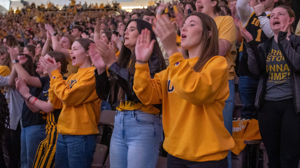 fans cheering on iowa hawkeye basketball